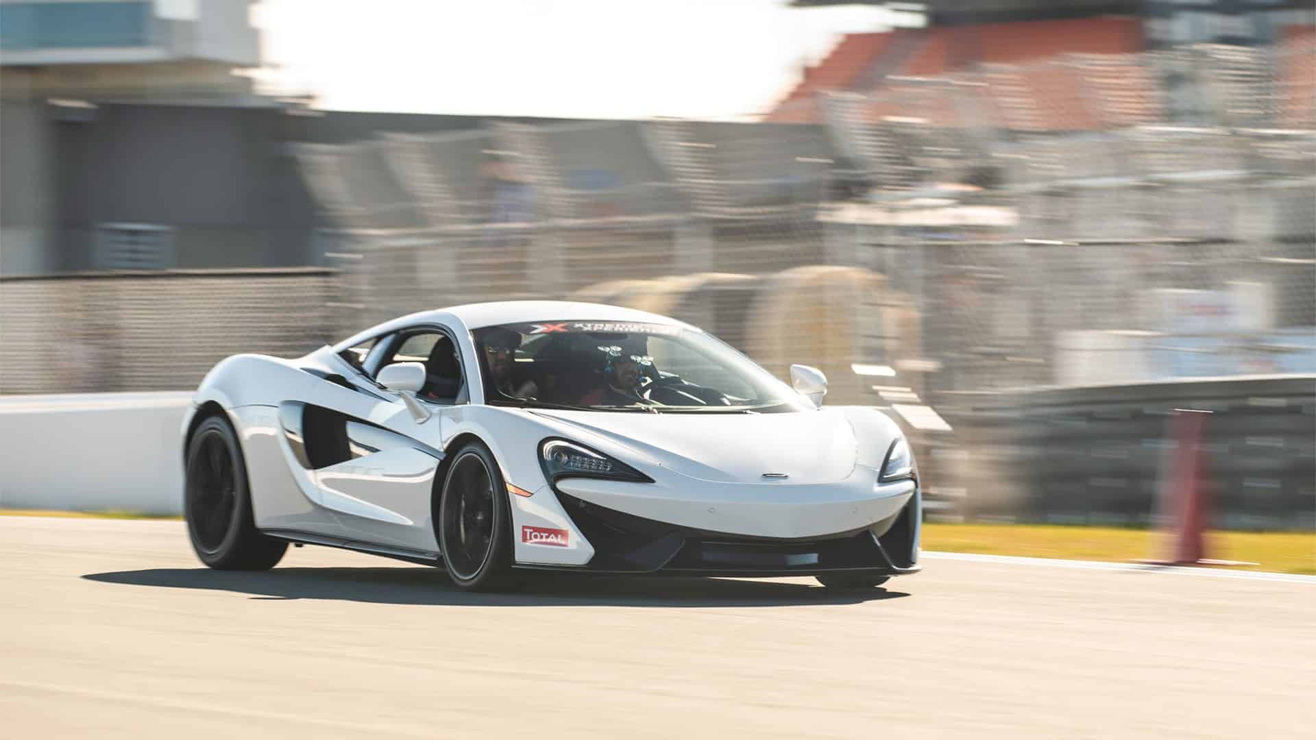 McLaren 570s in white on racetrack