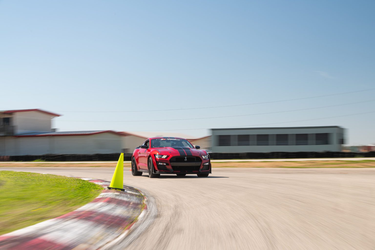 Xtreme Xperience.s Mustang Shelby GT500 driving on a racetrack