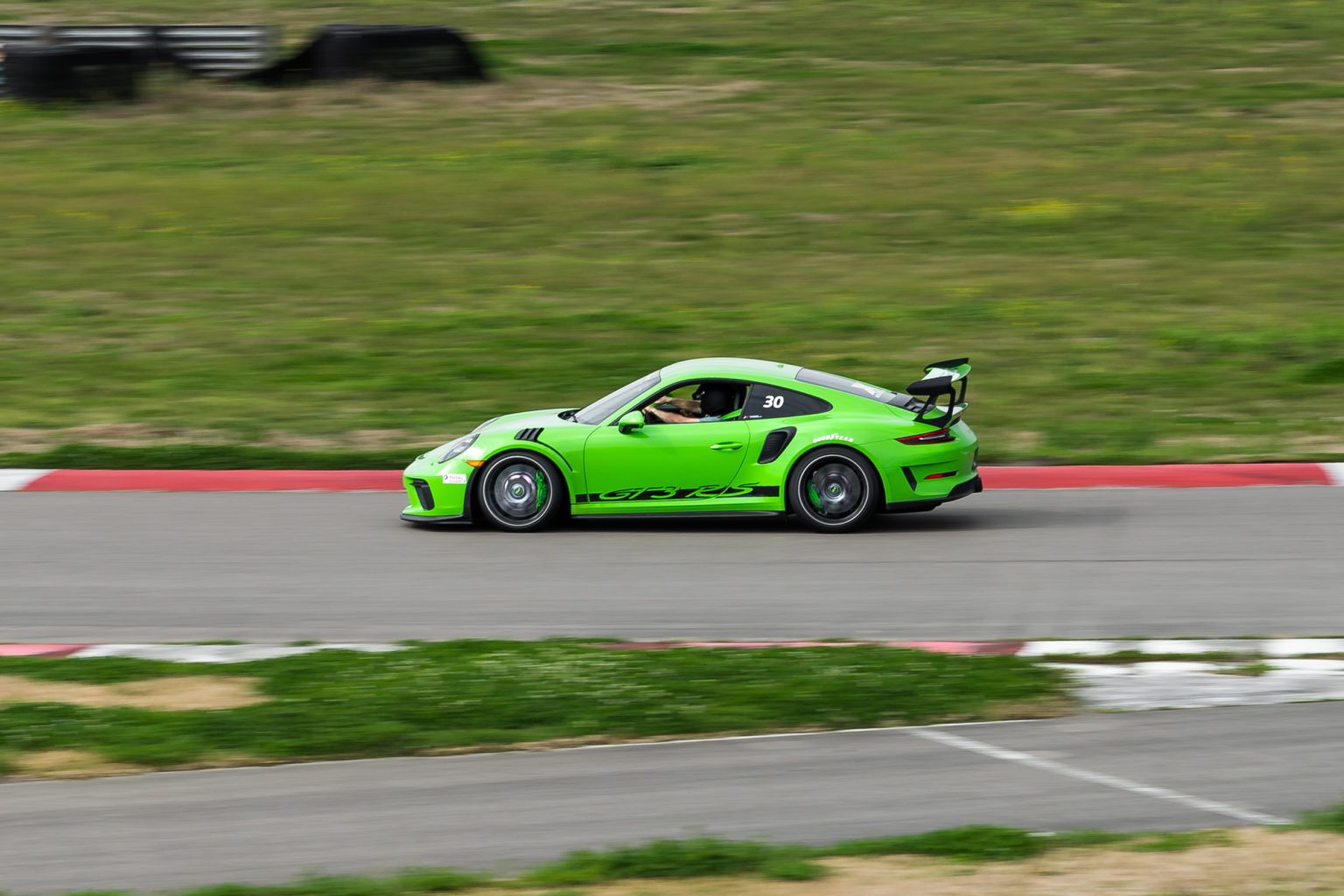 Xtreme Xperiences POrsche GT3 RS driving on a racetrack