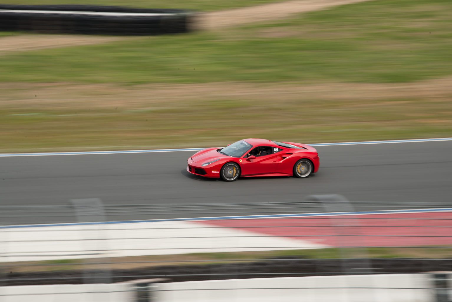 Xtreme Xperience's Ferrari 488 driving on a racetrack.